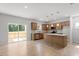 Open floor plan: view of the kitchen featuring stainless appliances, light wood cabinets, and a center island at 90 Cordoba Dr, Franklinton, NC 27525
