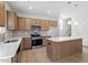 Spacious kitchen featuring stainless steel appliances, light wood cabinets, and a center island at 90 Cordoba Dr, Franklinton, NC 27525