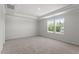 Spacious main bedroom featuring a tray ceiling, plush carpeting, and an abundance of natural light at 90 Cordoba Dr, Franklinton, NC 27525