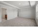 Spacious main bedroom featuring a tray ceiling, plush carpeting, and an abundance of natural light at 90 Cordoba Dr, Franklinton, NC 27525