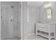 Bright bathroom featuring a glass-enclosed shower with white subway tile, niche, and a vanity with marble countertop at 9400 Wheelers Church E Rd, Hurdle Mills, NC 27541