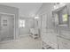 Elegant bathroom with double vanities, marble countertops, and a walk-in shower with subway tile at 9400 Wheelers Church E Rd, Hurdle Mills, NC 27541