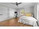 Comfortable bedroom featuring hardwood floors, ample closet space, and a ceiling fan at 9400 Wheelers Church E Rd, Hurdle Mills, NC 27541