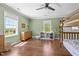 Spacious ' bedroom with a bunk bed, ceiling fan, and dresser with large window view at 9400 Wheelers Church E Rd, Hurdle Mills, NC 27541