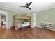 Cozy ' bedroom with a bunk bed, ceiling fan, and organized toy storage at 9400 Wheelers Church E Rd, Hurdle Mills, NC 27541
