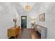 Charming entryway featuring shiplap walls, hardwood floors, stylish lighting, and tasteful decor at 9400 Wheelers Church E Rd, Hurdle Mills, NC 27541