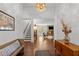 Inviting entryway showcasing hardwood floors, a staircase, and a glimpse into the living room with a stone fireplace at 9400 Wheelers Church E Rd, Hurdle Mills, NC 27541