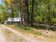 Home exterior seen from a tree lined driveway at 9400 Wheelers Church E Rd, Hurdle Mills, NC 27541