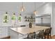 Open kitchen design with island, farmhouse sink, and stainless steel refrigerator at 9400 Wheelers Church E Rd, Hurdle Mills, NC 27541
