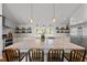 Kitchen island featuring marble countertop, barstool seating and pendant lighting at 9400 Wheelers Church E Rd, Hurdle Mills, NC 27541
