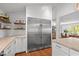 Modern stainless steel refrigerator in white kitchen with stone countertops at 9400 Wheelers Church E Rd, Hurdle Mills, NC 27541