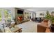 Spacious living room with a stone fireplace, hardwood floors, comfortable seating, and natural light at 9400 Wheelers Church E Rd, Hurdle Mills, NC 27541