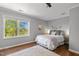 Bright bedroom featuring a comfortable bed, large window, and hardwood floors at 9400 Wheelers Church E Rd, Hurdle Mills, NC 27541
