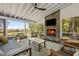 Comfortable screened porch with a stone fireplace, ceiling fan, and plenty of outdoor views at 9400 Wheelers Church E Rd, Hurdle Mills, NC 27541