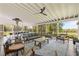 Inviting screened porch featuring comfortable seating, a dining table, and views of the serene outdoor landscape at 9400 Wheelers Church E Rd, Hurdle Mills, NC 27541