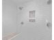 Modern shower with white subway tile, multiple showerheads, a built-in bench, and decorative tile accents at 9400 Wheelers Church E Rd, Hurdle Mills, NC 27541
