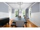 Formal dining room with wainscoting, large windows, dark table and upholstered chairs at 1023 Laura Johnson Rd, Pittsboro, NC 27312