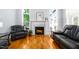 Close-up of a modern fireplace with a decorative mantel, flanked by windows and comfortable seating at 1023 Laura Johnson Rd, Pittsboro, NC 27312