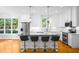 Bright kitchen with white cabinets, stainless appliances and a large island with barstool seating at 1023 Laura Johnson Rd, Pittsboro, NC 27312