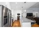Spacious kitchen with stainless steel appliances, white cabinets, island, and open layout at 1023 Laura Johnson Rd, Pittsboro, NC 27312