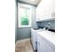 Convenient laundry room with modern appliances and ample cabinet space at 1023 Laura Johnson Rd, Pittsboro, NC 27312