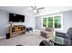 Inviting living area with large window, fan, and comfortable seating at 1023 Laura Johnson Rd, Pittsboro, NC 27312