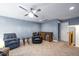 Entertainment area with bar cabinet, cozy seating, and ceiling fan at 1023 Laura Johnson Rd, Pittsboro, NC 27312