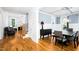 Open concept living space showcasing hardwood floors, modern staircase, fireplace, and seamless flow to the dining area at 1023 Laura Johnson Rd, Pittsboro, NC 27312