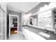Bright bathroom boasts double sinks, a large mirror, and a marble tiled shower at 1023 Laura Johnson Rd, Pittsboro, NC 27312