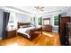 Spacious main bedroom with hardwood floors, tray ceiling, and natural light at 1023 Laura Johnson Rd, Pittsboro, NC 27312