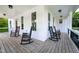 Wraparound porch featuring rocking chairs and offering ample space to relax at 1023 Laura Johnson Rd, Pittsboro, NC 27312