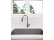 Close up view of kitchen sink with chrome faucet and white backsplash tiles at 1023 Laura Johnson Rd, Pittsboro, NC 27312
