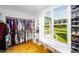 Spacious walk-in closet with ample storage, shelving, and a window overlooking backyard at 1023 Laura Johnson Rd, Pittsboro, NC 27312