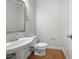 Simple half bath with a modern sink, toilet, and mirror at 103 Loch Ryan Way, Cary, NC 27513