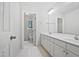 Bright bathroom featuring a double sink vanity with ample storage and a doorway leading to a separate toilet room at 103 Loch Ryan Way, Cary, NC 27513