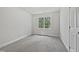 Cozy bedroom with plush carpeting and a bright window providing natural light and a view of the outdoors at 103 Loch Ryan Way, Cary, NC 27513
