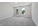 Empty bedroom with neutral carpet and two large windows for ample natural light at 103 Loch Ryan Way, Cary, NC 27513