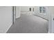 Spacious upper level bonus room with plush carpeting and natural light from several windows, adjacent to the stairway at 103 Loch Ryan Way, Cary, NC 27513