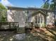 Charming backyard exterior with a wooden deck, stairs, and mature trees at 103 Loch Ryan Way, Cary, NC 27513