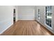 Spacious living room with hardwood floors and large windows for plenty of natural light at 103 Loch Ryan Way, Cary, NC 27513