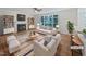 Bright, staged living room featuring a fireplace, large windows, and modern furnishings at 103 Loch Ryan Way, Cary, NC 27513