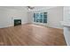 Spacious living room with hardwood floors, a fireplace, and large windows at 103 Loch Ryan Way, Cary, NC 27513
