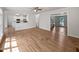 Open-concept living space with hardwood floors, white walls, and abundant natural light at 103 Loch Ryan Way, Cary, NC 27513