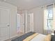 Bright bedroom with large windows, stylish curtains, plush carpet, and ensuite bathroom at 1046 Winding Spring Dr, Mebane, NC 27302