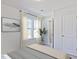 Serene bedroom featuring natural light, neutral tones, stylish curtains, and a view of the outdoors at 1046 Winding Spring Dr, Mebane, NC 27302