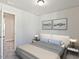 Bright bedroom with neutral decor, plush carpet, and ambient lighting from bedside lamps and a ceiling fixture at 1046 Winding Spring Dr, Mebane, NC 27302