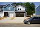 New two-story townhouse with open garage and modern design elements at 1046 Winding Spring Dr, Mebane, NC 27302
