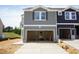 New construction townhome featuring a two-car garage and light gray horizontal siding at 1054 Winding Spring Dr, Mebane, NC 27302