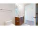 Bathroom features a wood vanity with chrome fixtures, white tile floors, and a large mirror at 110 N Corcoran St # 2101, Durham, NC 27701