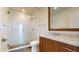 Bright bathroom featuring a glass enclosed shower, wood vanity, and marble countertops at 110 N Corcoran St # 2101, Durham, NC 27701